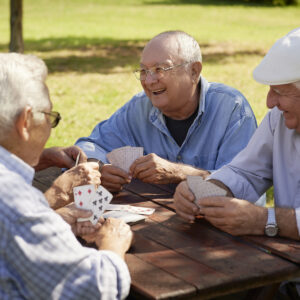 Senior men playing cards for socia media